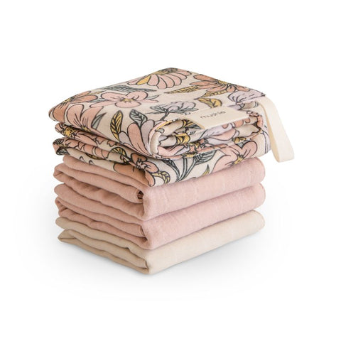 Stack of folded blankets with floral pattern on a white background