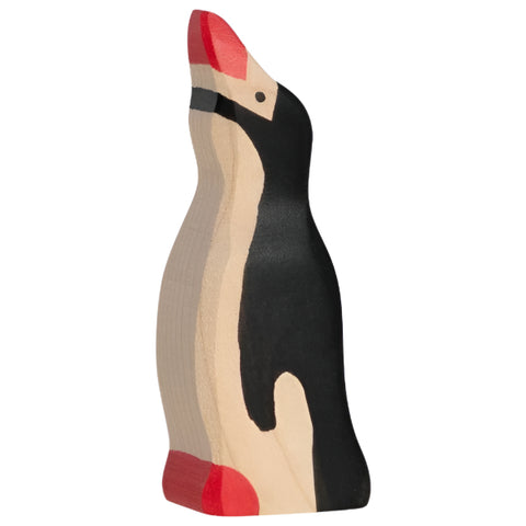 Wooden penguin toy with a red beak and feet on a white background