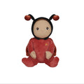 Plush toy in a red outfit with black hair on a white background