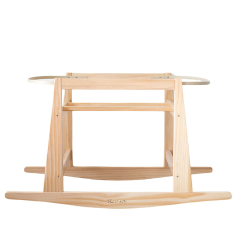 Wooden baby rocker on a wooden floor with a white wall background